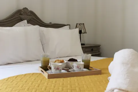 A breakfast tray on the yellow quilt